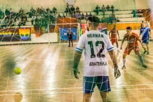 COB e CBF unidos por Pan 2031 e inclusão do futsal nas Olimpíadas Goalkeeper watches incoming players in an intense indoor soccer match.